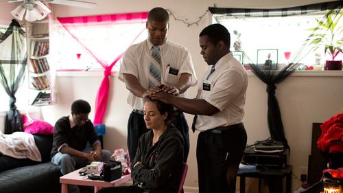 missionaries giving a blessing to a woman