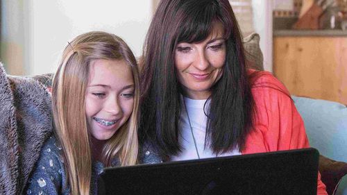 woman and child looking at computer