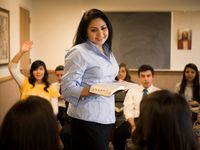 woman teaching class of youth