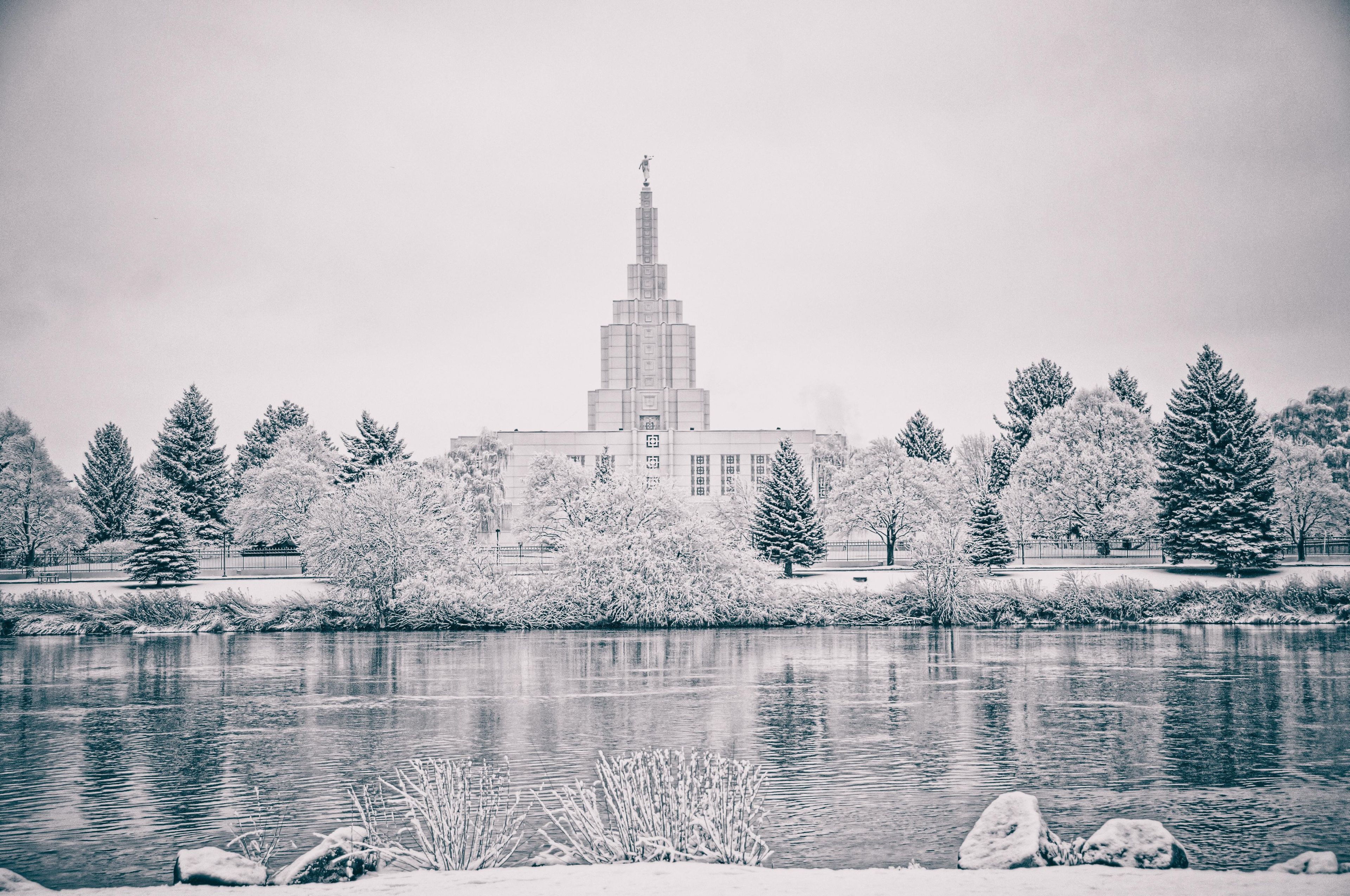 The Idaho Falls Idaho Temple and grounds covered in snow in the winter.