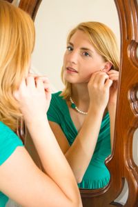 young woman with reflection in mirror