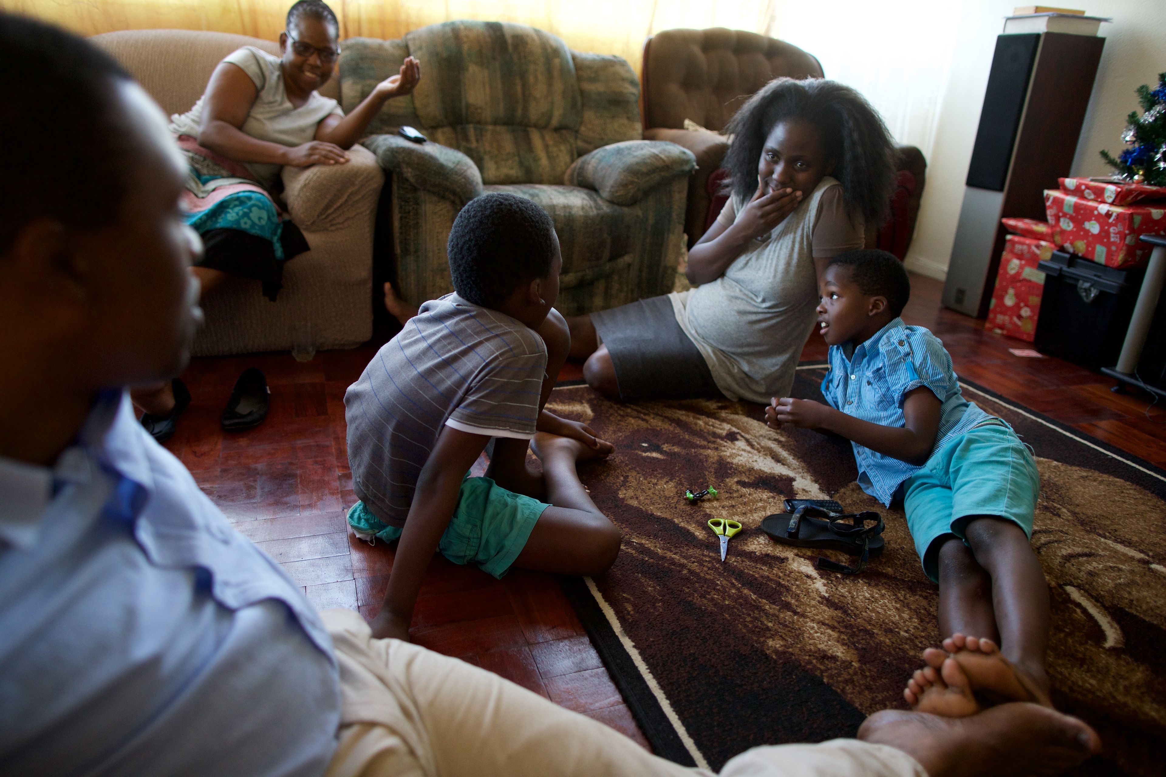 A South African family spends time together in their sitting room at Christmastime.