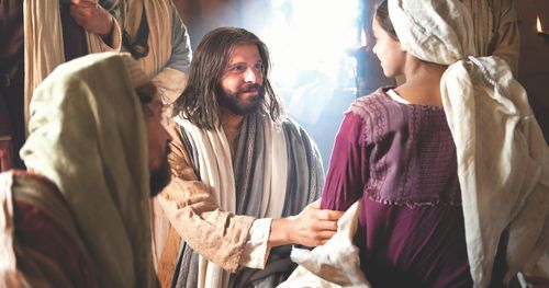 Jesus is smiling at the daughter of Jairus who was raised from the dead, her father is in the foreground and some disciples in the background.