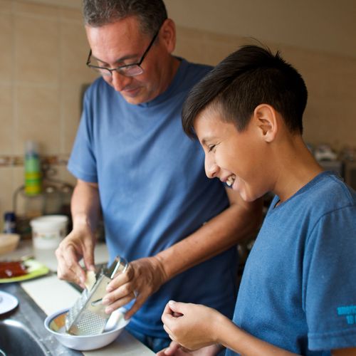 man and young man cooking