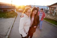 A family walks down a street enjoying one another