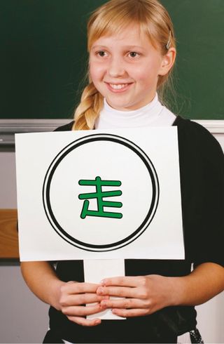 girl standing in front of chalkboard