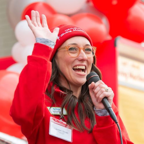 Lauren Smith standing by Giving Machines talking into a microphone