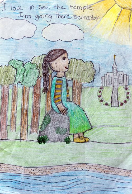 A child's colored drawing of a young girl with long braided hair sitting on a rock looking at a temple.- Trees are around, and the sun is out.  She's written "I love to see the Temple I'm going there someday."