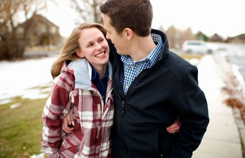 a young couple hugging and looking at each other