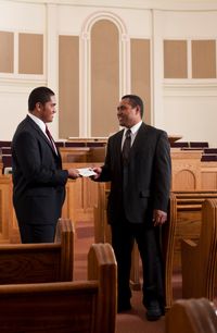 young man paying tithing