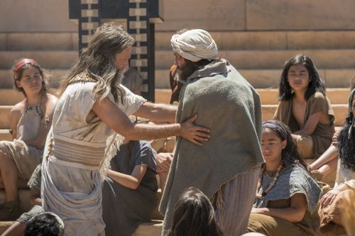 Jacob helps a disabled man as the Nephites gather at the temple.