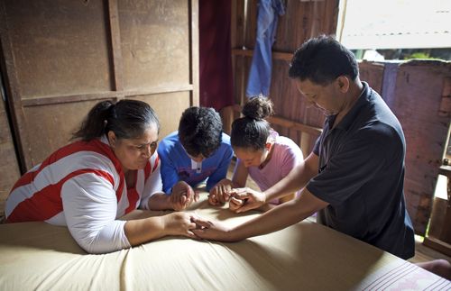 family praying together