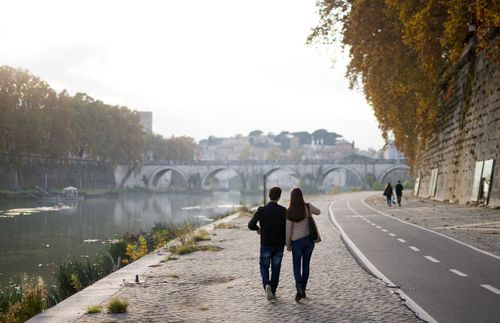 a couple holding hands and walking together