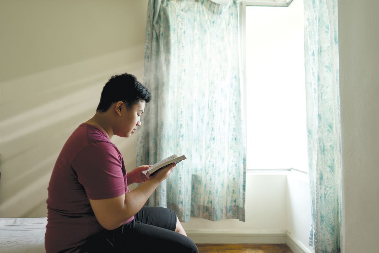 A woman reading the Book of Mormon