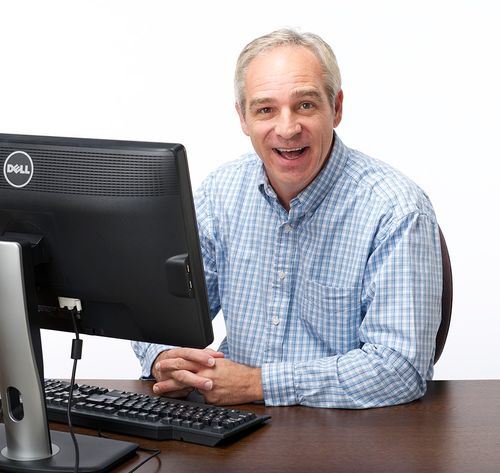 man with blue shirt and computer