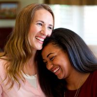 Young woman and adult woman hugging