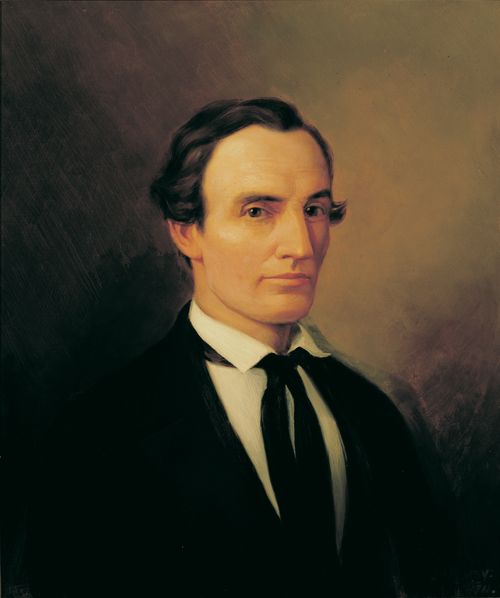 Head and shoulders portrait of Oliver Cowdery as a young man. He is wearing a dark suit, white shirt and dark tie.