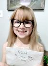 Smiling girl holding tithing envelope