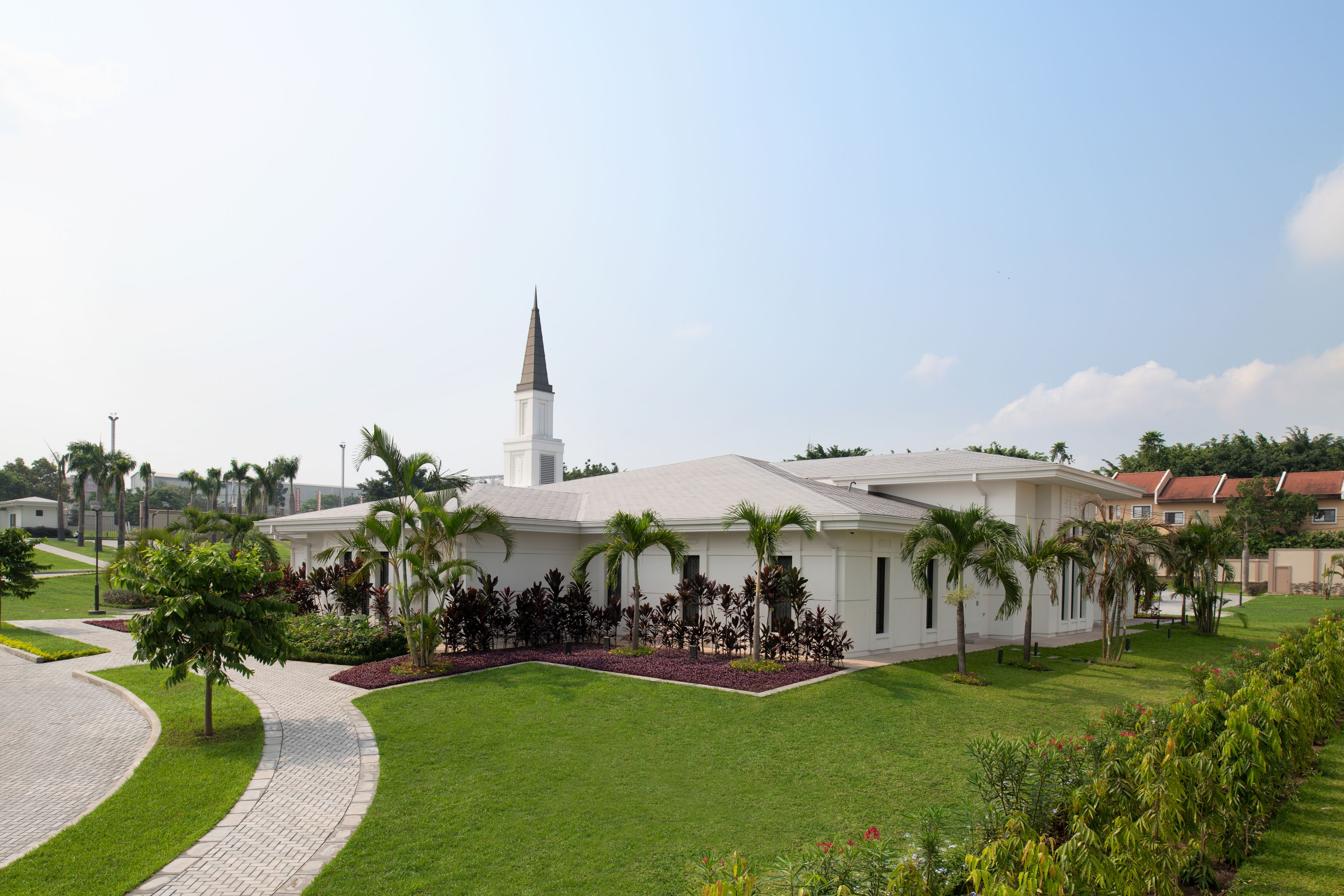 An exterior view of the Kinshasa Democratic Republic of the Congo Temple showing the front walkway and grounds.