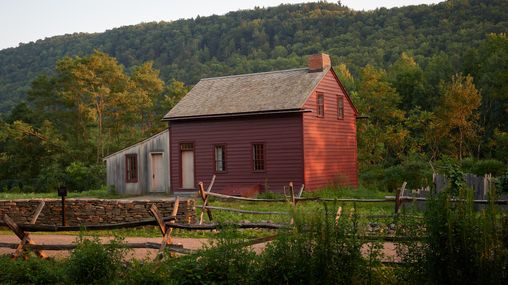 An exterior shot of farm houses in Waterloo, New York.There are trees and paths all along the way.