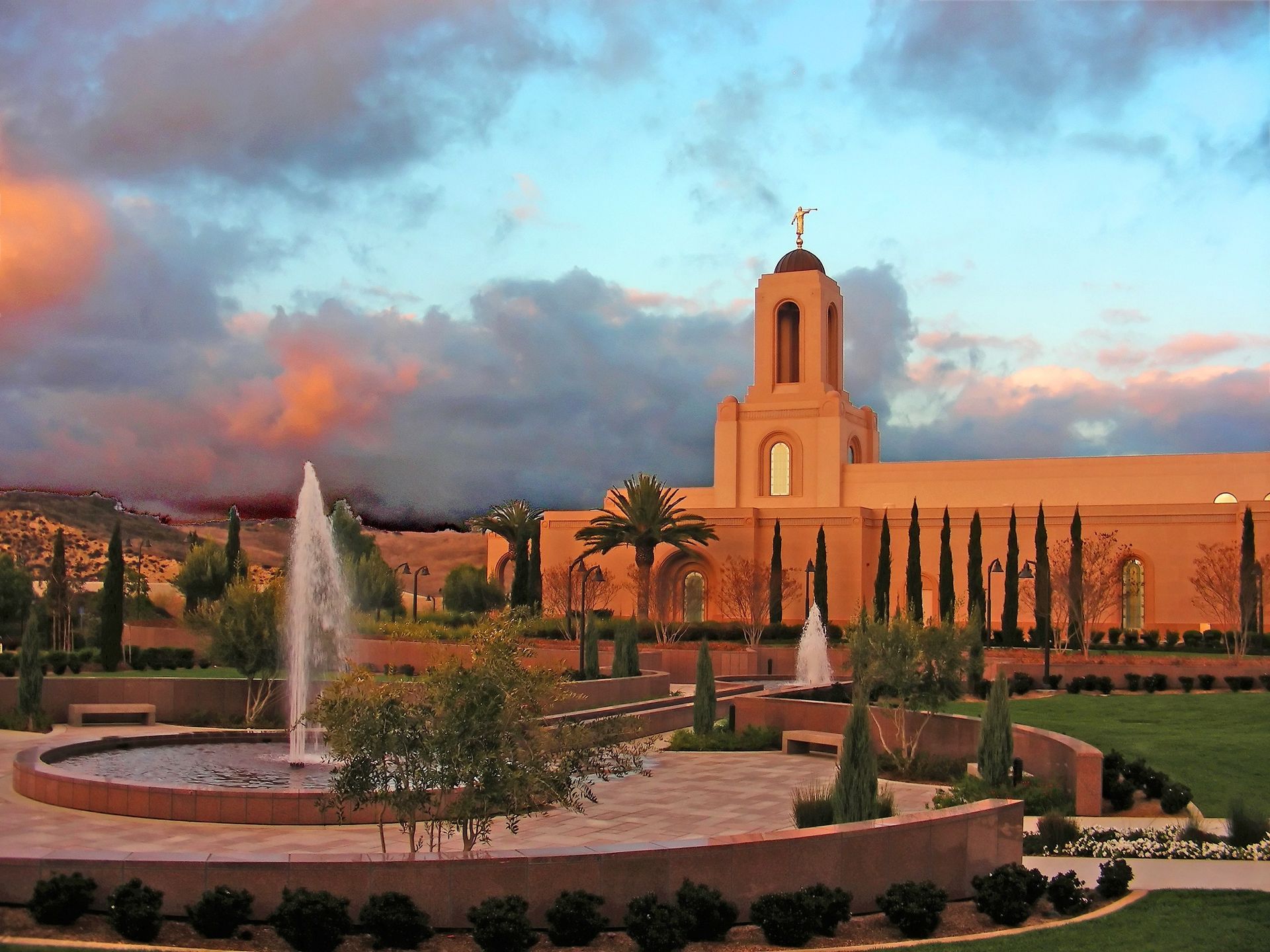 The Newport Beach California Temple at sunset, including fountains and scenery.