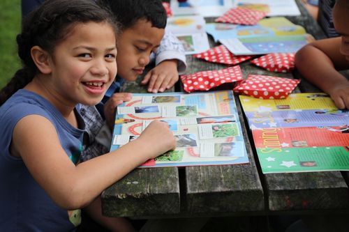 children looking at magazines