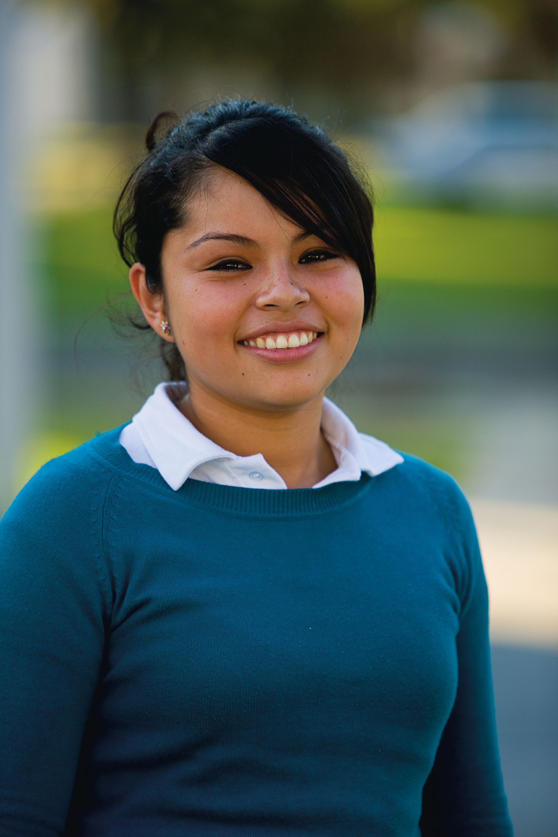 A portrait of a young woman in Mexico smiling.