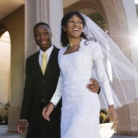 A newly married bride and groom walking outside the Newport Beach California Temple. Why Temple Marriage?