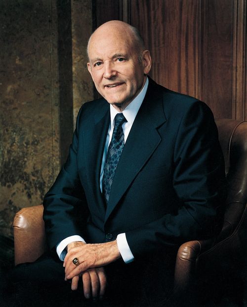 A portrait photograph by Merrett T. Smith of Howard W. Hunter in a dark suit, sitting in a leather chair.