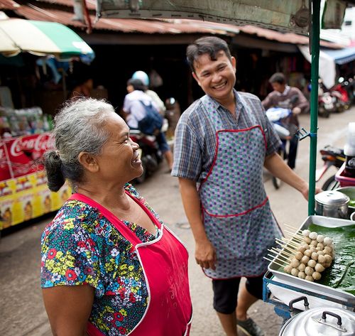 man and woman at street food stall