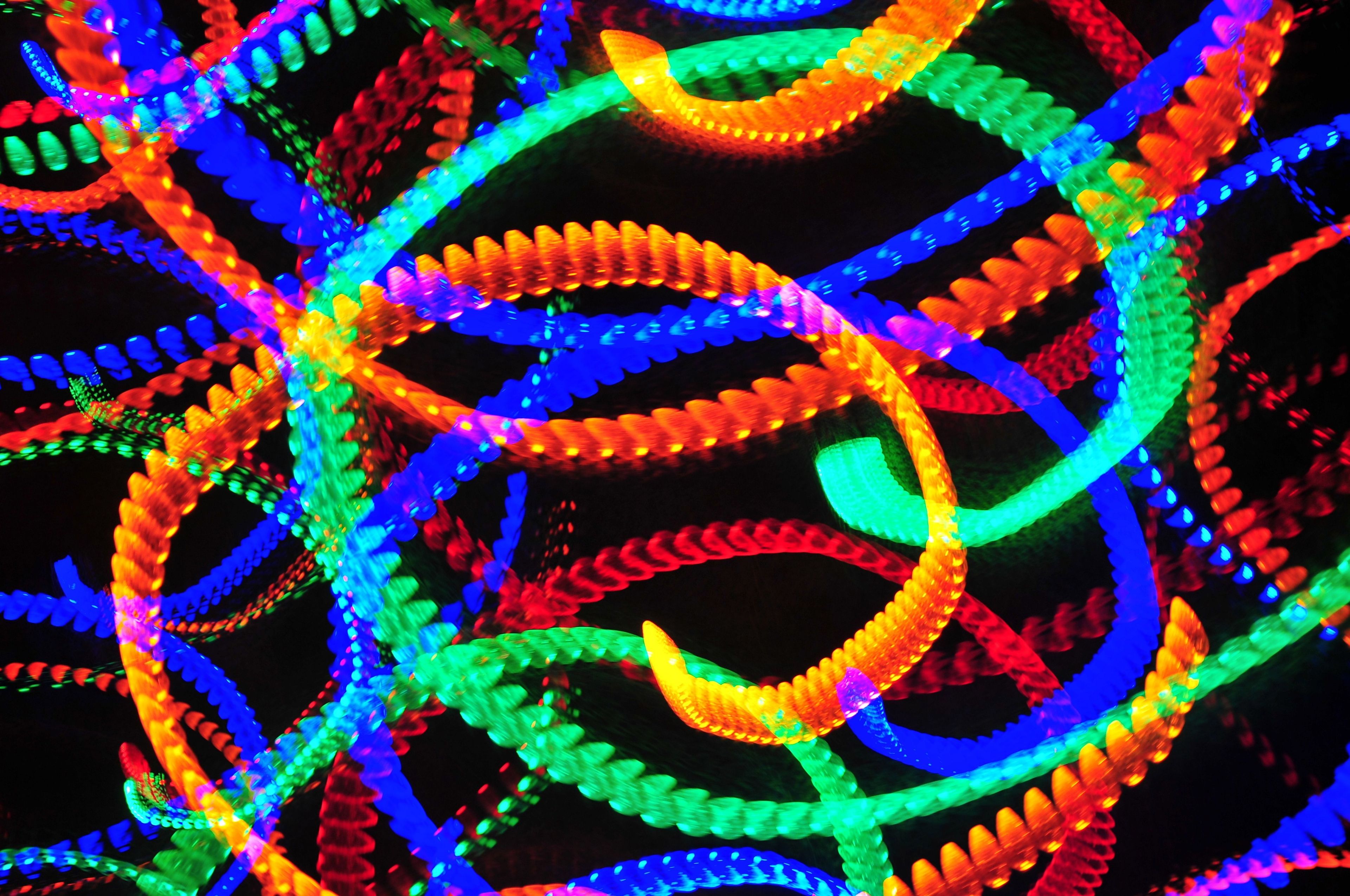 Multicolored lights blurred in long swirls against a black background.
