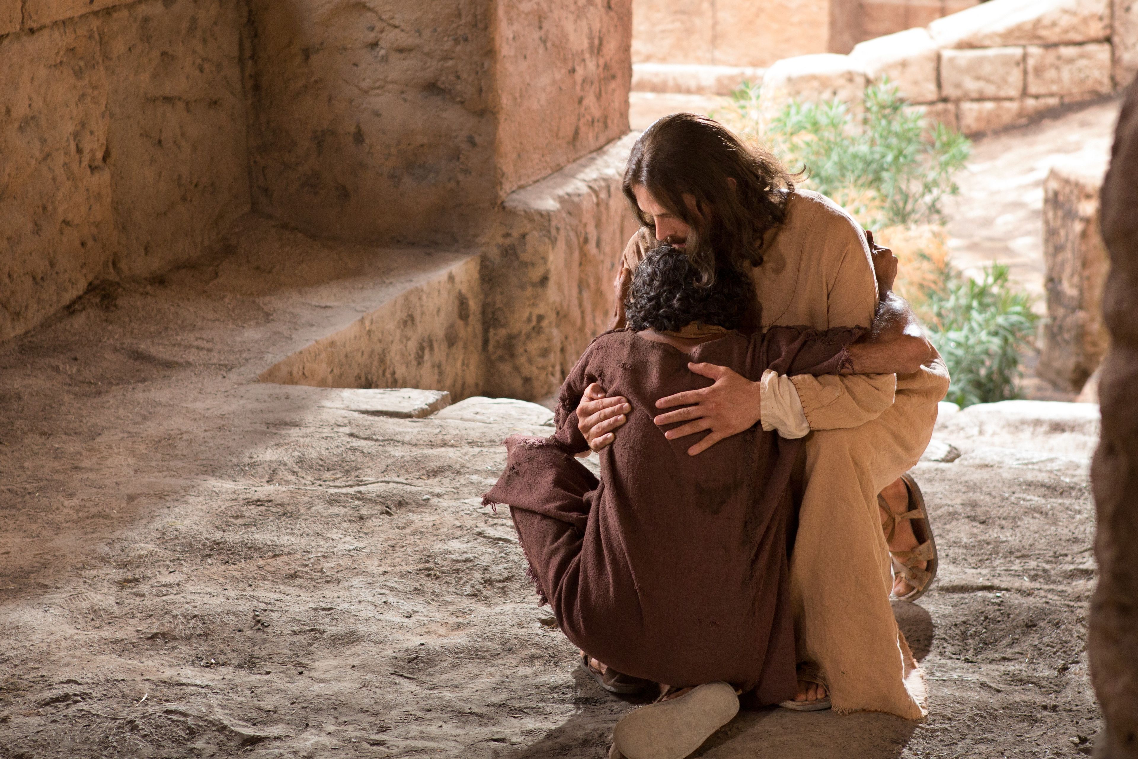 The blind man, now healed, hugging Christ in a gesture of gratitude.
