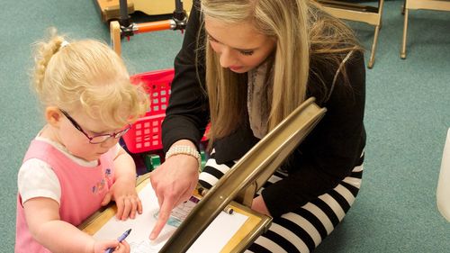 woman reading to child