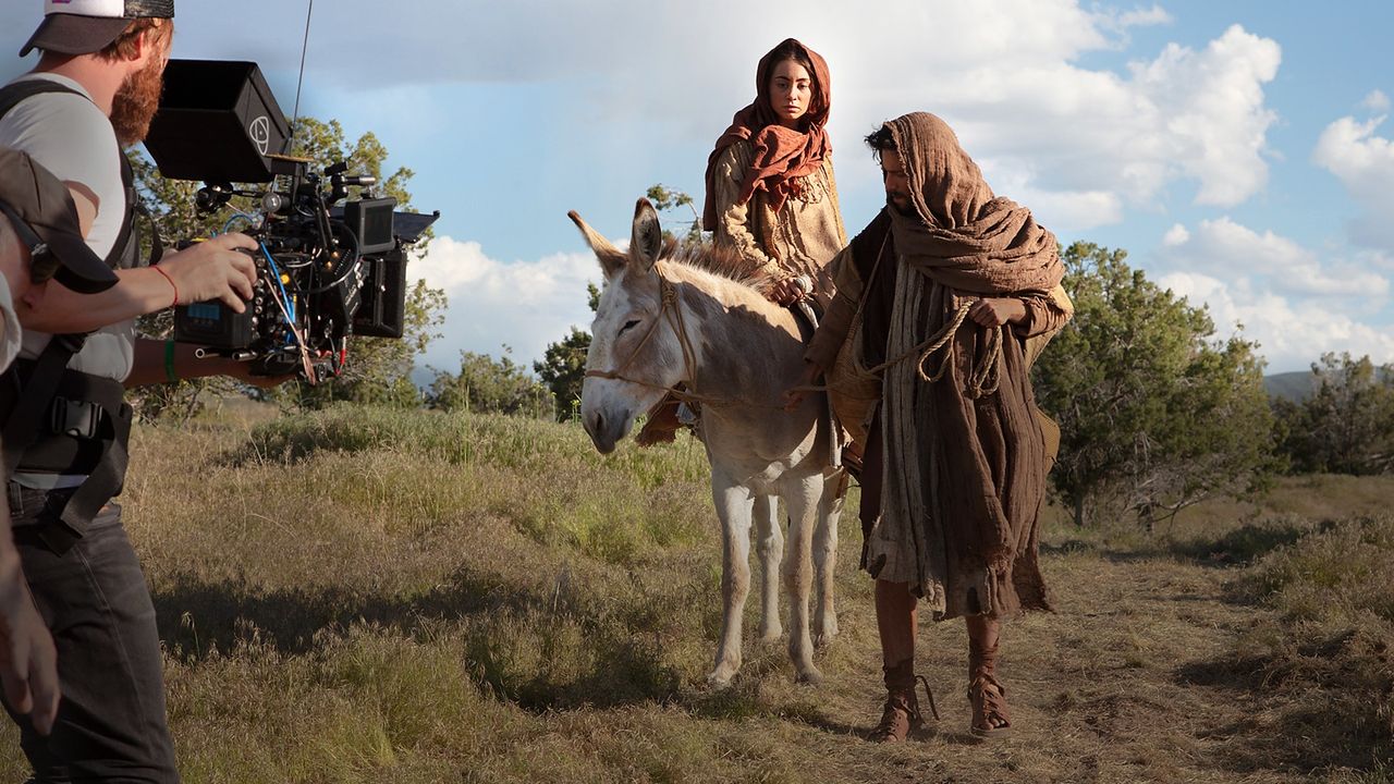 A camera operator films actors playing Mary and Joseph