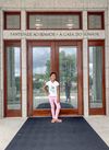 Smiling girl standing in front of temple