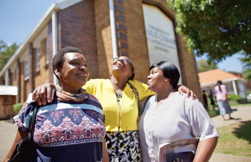 women standing in front of church building