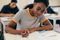 Young woman and others studying at a university.