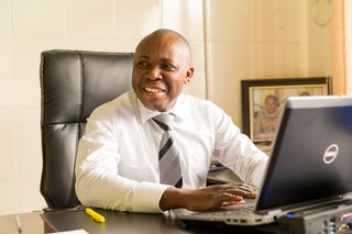 A man in an office working on a computer in DR Congo.