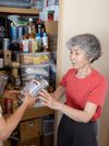 woman receiving canned food