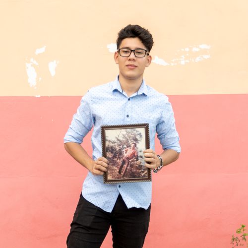 young man with framed photo