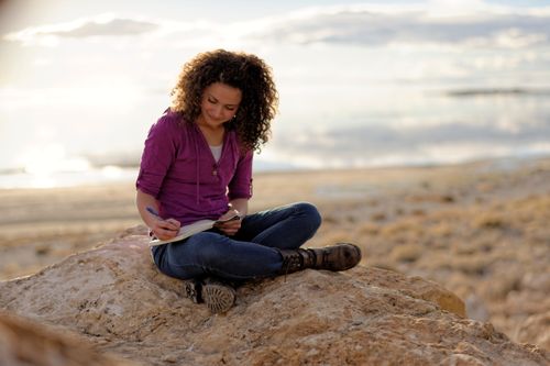 woman writing in a journal