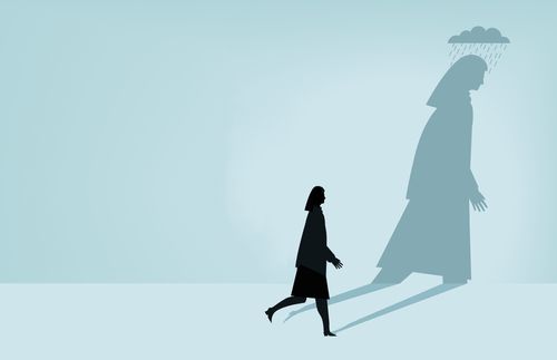silhouette of a woman walking and her shadow