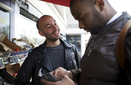 Cayo and Anthony in front of a market