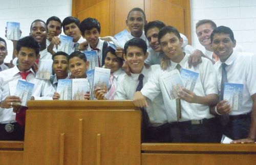 Young Men  on the stand holding pamphlets