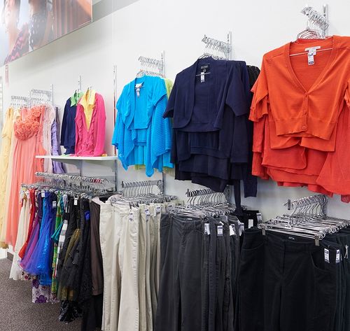 women’s clothes hanging in store