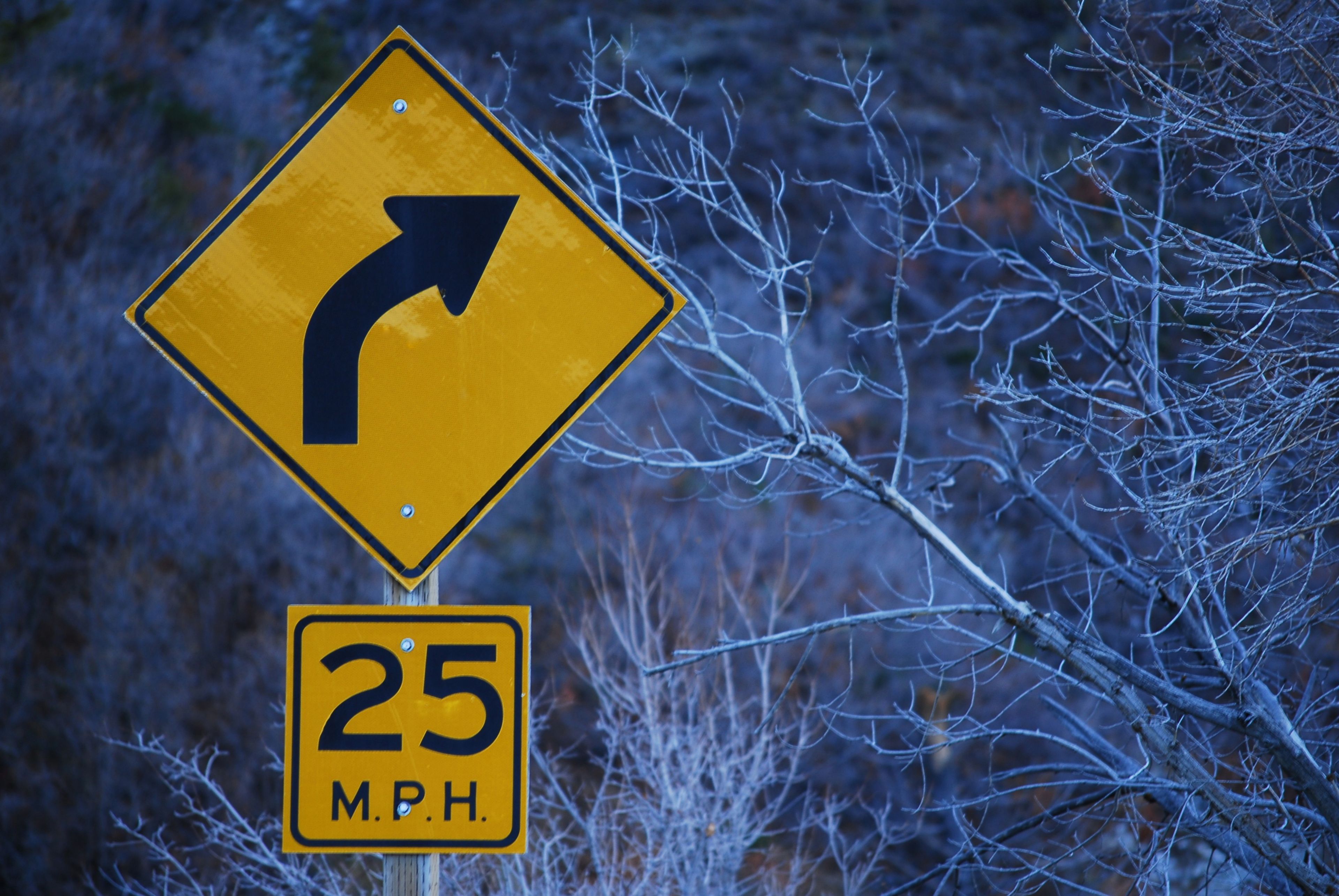 A “25 miles per hour” street sign in the cold winter.