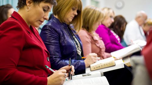 women taking notes in a class