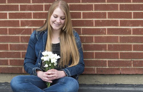 Young adult woman holding flowers