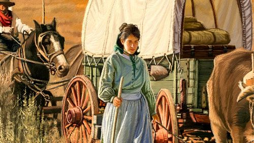 Vienna Jacques walking next to covered wagon