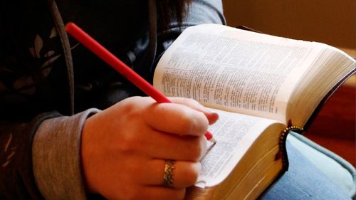 a youth marking the scriptures